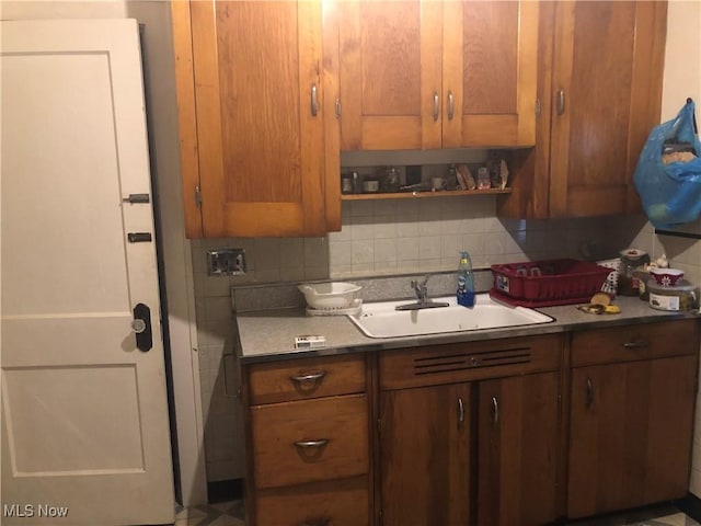 kitchen with backsplash and a sink