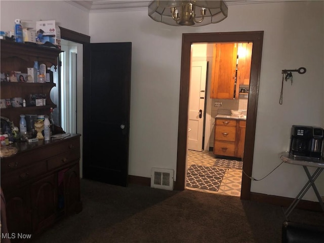 interior space with light floors, visible vents, and crown molding