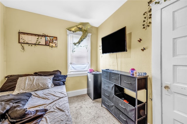 bedroom with light carpet and baseboards