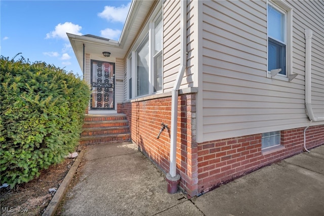 view of side of property featuring brick siding