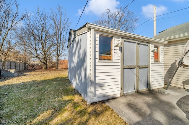 view of shed featuring fence