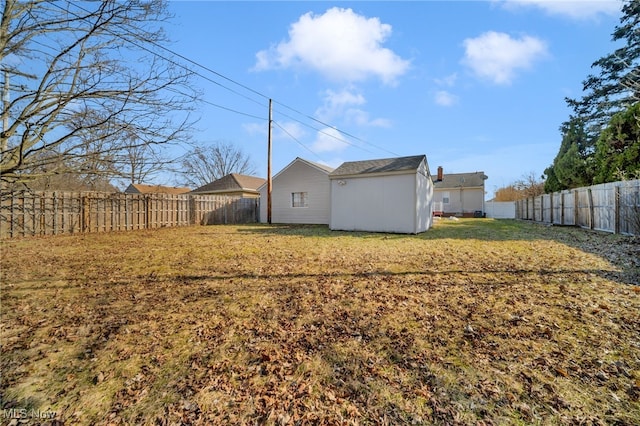 view of yard featuring a fenced backyard and an outbuilding