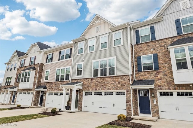 townhome / multi-family property featuring driveway, a garage, and board and batten siding