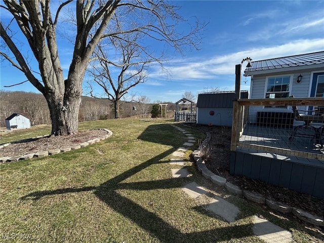 view of yard with an outbuilding and a deck