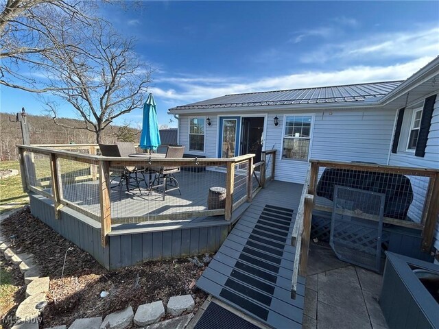 wooden deck featuring outdoor dining space