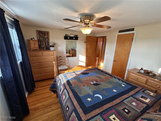 bedroom with a ceiling fan and light wood-style floors