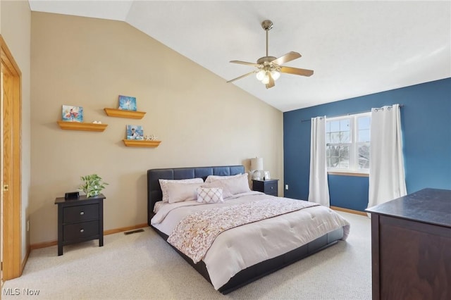 bedroom with visible vents, baseboards, light colored carpet, ceiling fan, and vaulted ceiling