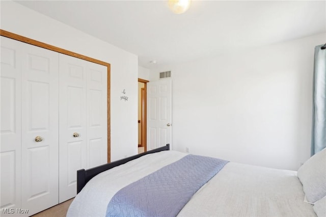 bedroom featuring a closet and visible vents