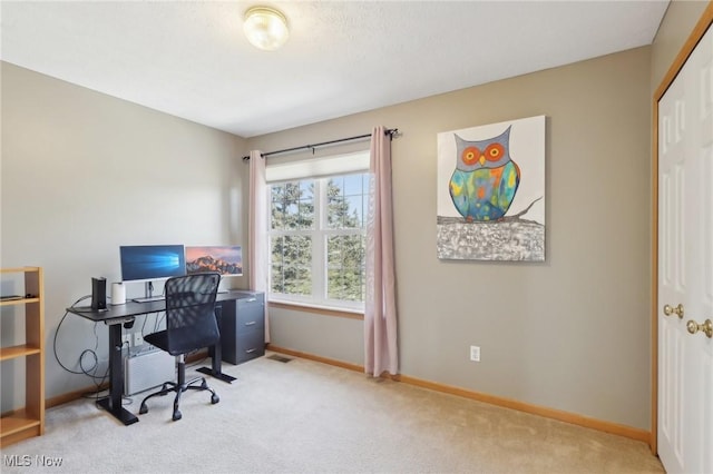 carpeted home office with baseboards