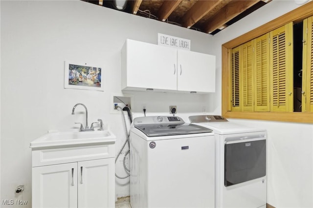 laundry area featuring washer and clothes dryer, a sink, and cabinet space