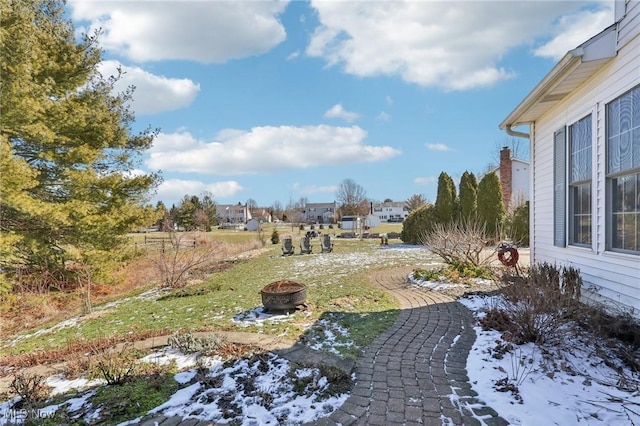 view of yard with a fire pit