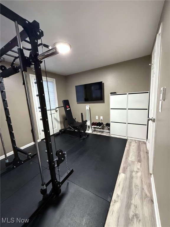 workout area with wood finished floors