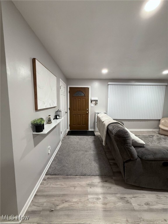 entrance foyer featuring baseboards and wood finished floors