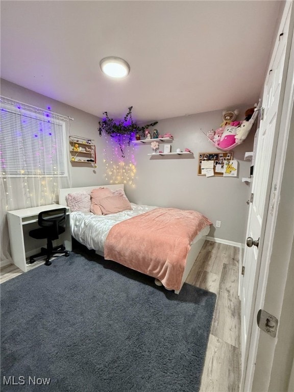 bedroom featuring wood finished floors