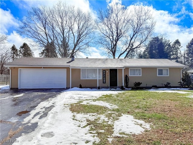 ranch-style home featuring a garage, driveway, and a front yard