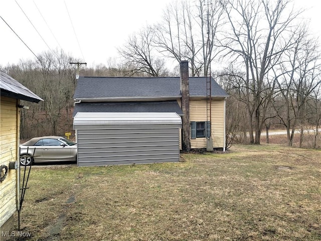 view of side of home featuring a lawn and a chimney