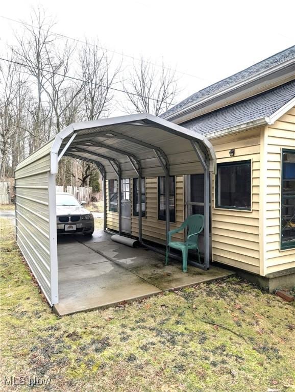 view of parking / parking lot featuring a detached carport and driveway