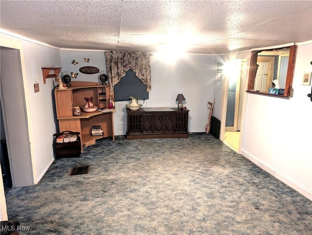 interior space featuring carpet flooring, visible vents, and a textured ceiling