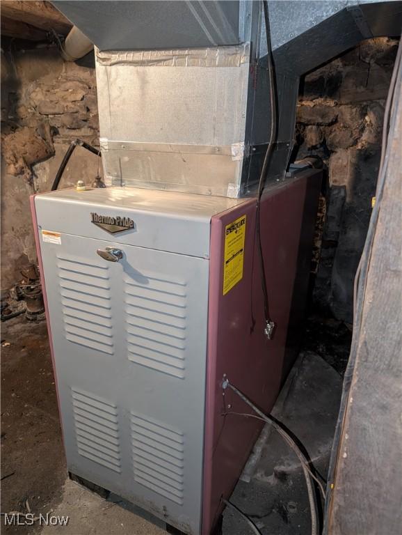 utility room featuring heating unit