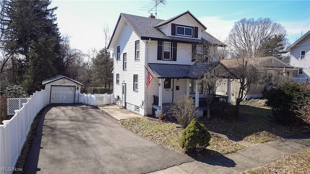 american foursquare style home featuring an outbuilding, roof with shingles, fence, a garage, and driveway