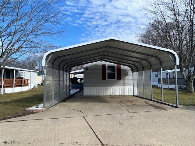 view of vehicle parking featuring a detached carport and concrete driveway