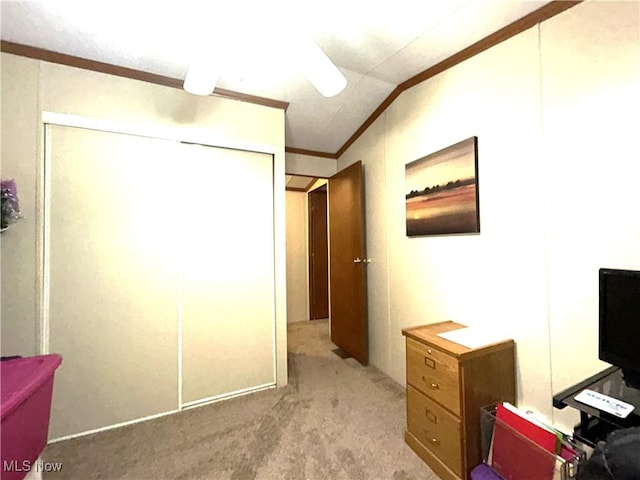 home office featuring lofted ceiling, ornamental molding, and light colored carpet