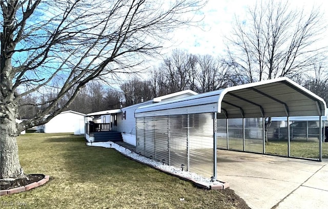 exterior space featuring driveway, a lawn, and a detached carport