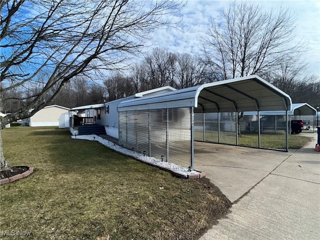 exterior space featuring a carport, a lawn, and driveway