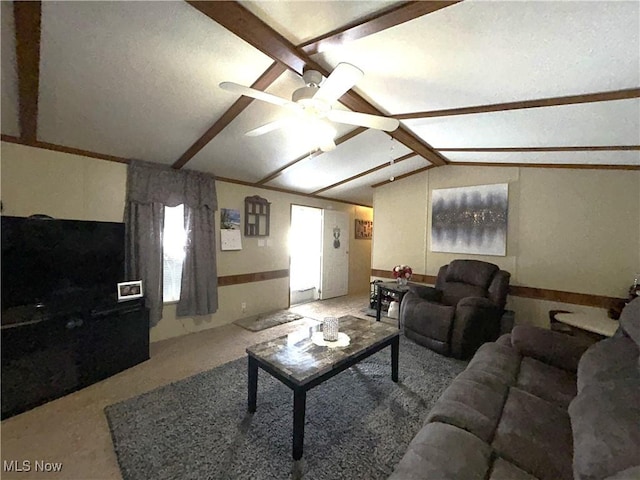 living area with vaulted ceiling with beams and a ceiling fan