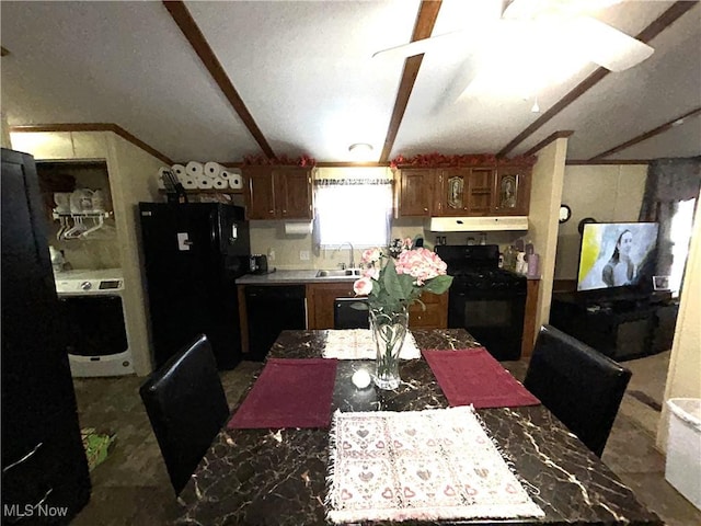 kitchen featuring under cabinet range hood, a sink, vaulted ceiling, light countertops, and black appliances