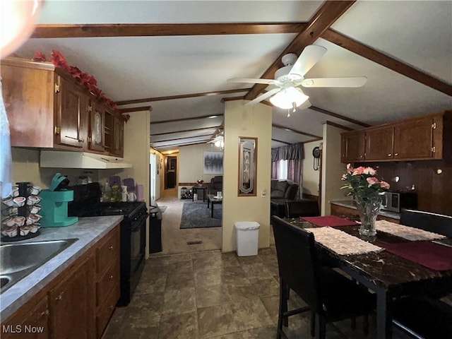 kitchen with vaulted ceiling with beams, a ceiling fan, black range with gas cooktop, a sink, and under cabinet range hood