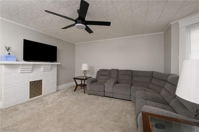 carpeted living room featuring ceiling fan, baseboards, and crown molding