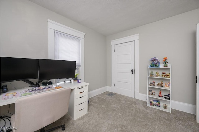 carpeted home office featuring baseboards