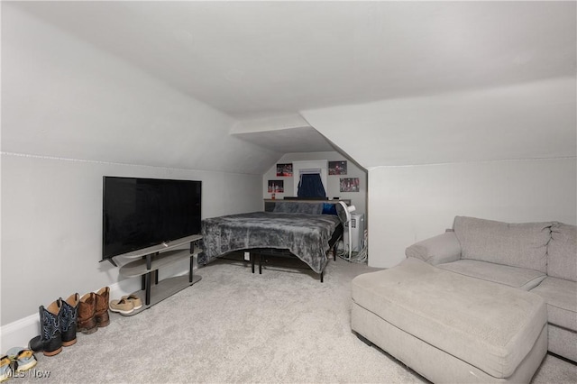 bedroom featuring vaulted ceiling and carpet flooring