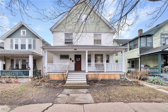 american foursquare style home with covered porch