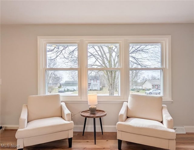 sitting room featuring baseboards and wood finished floors