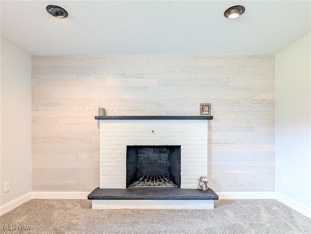 room details with a textured ceiling, carpet floors, and baseboards