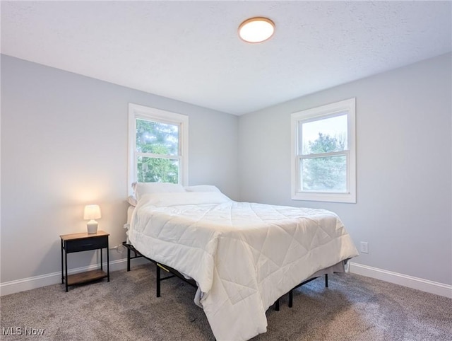 bedroom with baseboards and carpet flooring