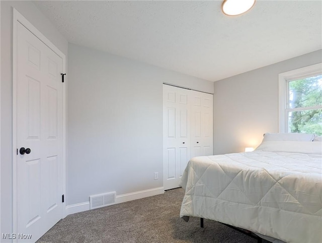 bedroom featuring carpet, a closet, visible vents, and baseboards