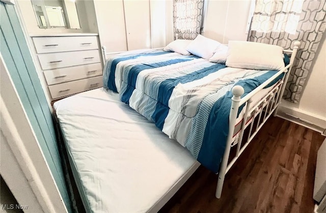 bedroom featuring dark wood-style flooring