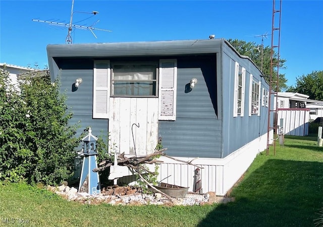 view of property exterior featuring a lawn