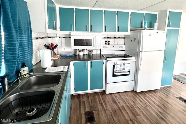 kitchen with blue cabinetry, decorative backsplash, dark wood-type flooring, a sink, and white appliances