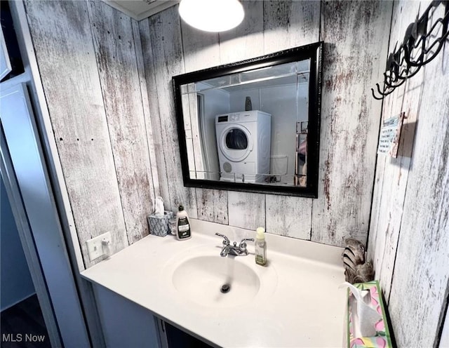 bathroom featuring vanity and washer / dryer