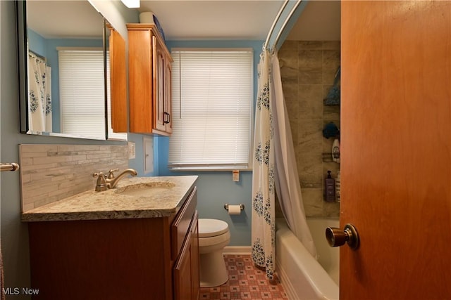 bathroom with toilet, shower / tub combo, vanity, baseboards, and decorative backsplash