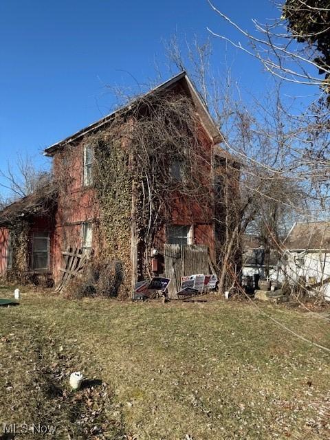 view of side of home with a lawn