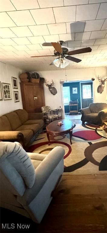 living room with ceiling fan and wood finished floors