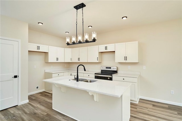 kitchen featuring a sink, light wood-style floors, white cabinets, and electric stove