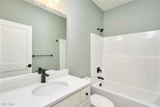 bathroom with shower / bathing tub combination, vanity, and toilet