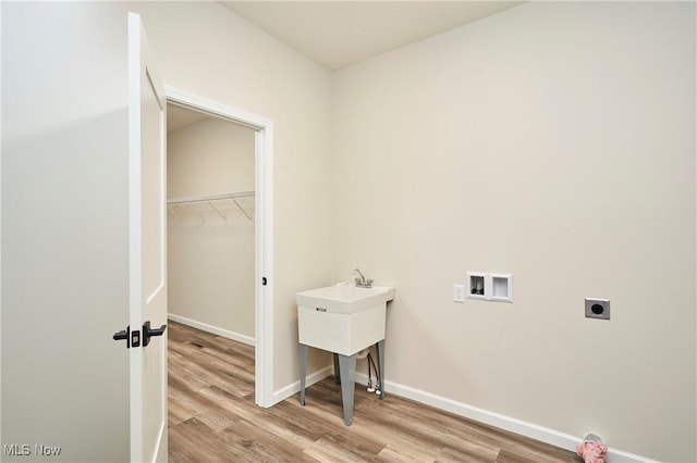 clothes washing area with laundry area, washer hookup, light wood-style floors, and electric dryer hookup