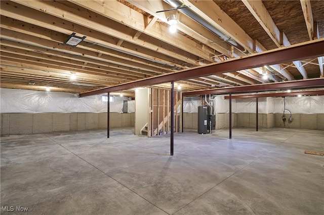 unfinished basement featuring water heater